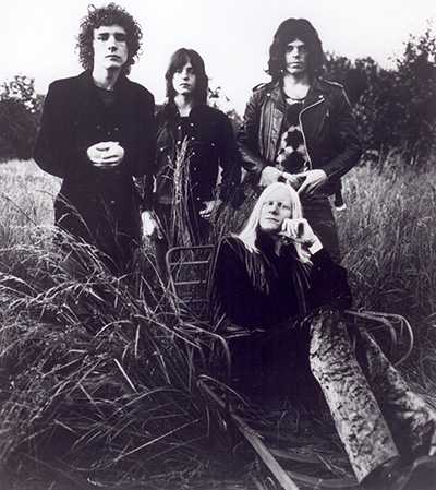 Photo of the Johnny Winter AND band with Johnny Winter posing on a stretcher